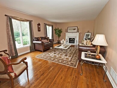 The generous & elegant living room features a fire