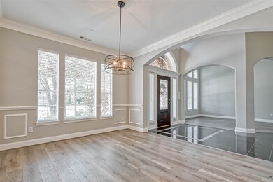 The spacious formal dining features a new updated light fixture and double crown molding. Notice the new flooring in both formals!