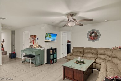 Tiled living room with ceiling fan