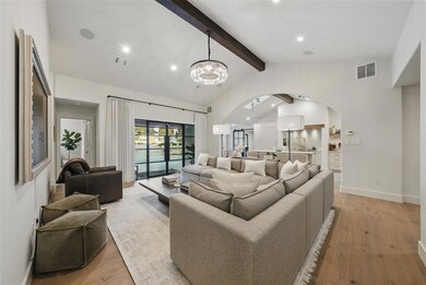 Living room with arched walkways, light wood-styl
