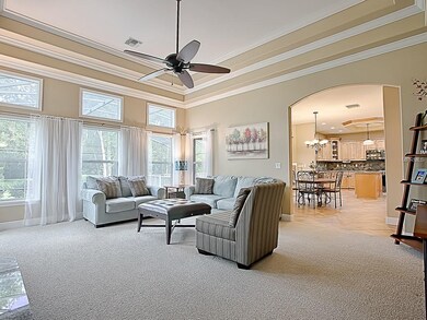 Living room has dramatic ceiling and lots of windo