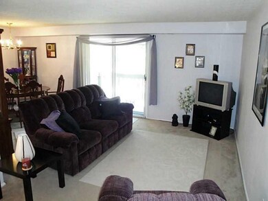 Living Room. The combination living and dining area has a neutral color palette and plentiful natural light, sure to make interior design a breeze.