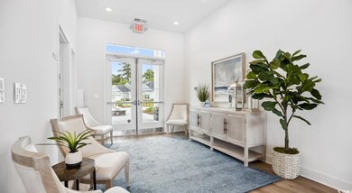 Sitting room with french doors, wood finished floors, and recessed lighting