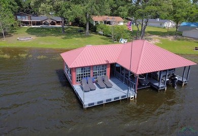 Dock area featuring a lawn and a water view