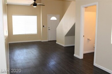 Entryway featuring baseboards, dark wood-style flo