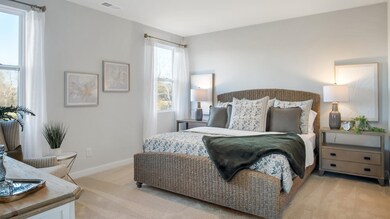 Bedroom featuring light colored carpet