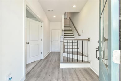 Entryway featuring baseboards, stairway, visible v