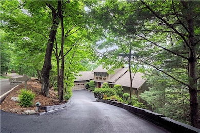 Gentle driveway (recently widened and sealed) leads to XL 2-Car Garage and extended parking pad.