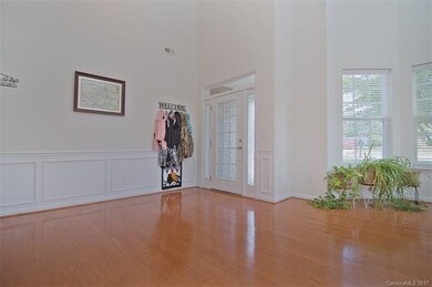 Large living room with wood flooring, lots of wind