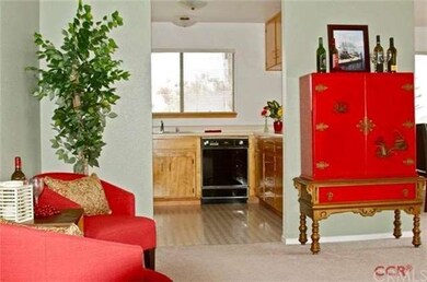 Looking into kitchen and living area upon entering