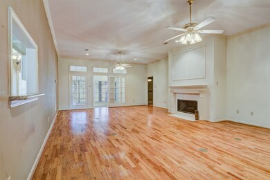 Very large living area with gas log fireplace and gorgeous hardwood floors, large ceiling fans and a sunroom located just to the side of the living area.