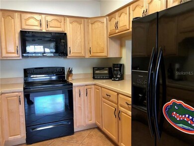 All black appliances, note pass-thru to Dining are