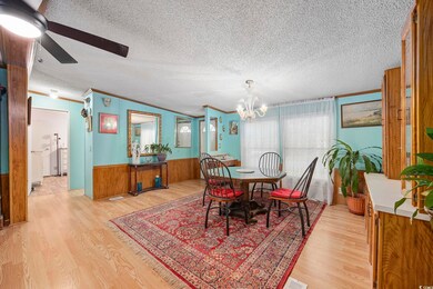 Dining area with wooden walls, ceiling fan with no