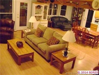 Open living room with wood burning stove.