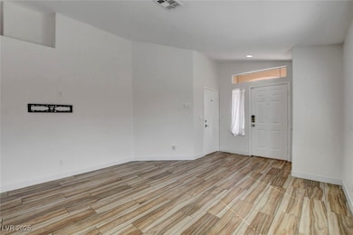 Entryway with wood finish floors and baseboards