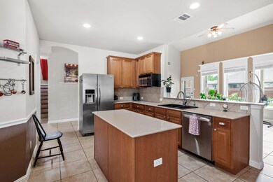 Kitchen with visible vents, a peninsula, light co