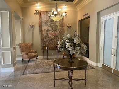 club house with ornamental molding, a chandelier, and french doors