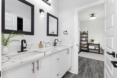 Bathroom featuring double vanity, wood finished f