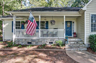 Enter through the covered front porch which is perfect for rocking chairs and cool all day thanks to the shade trees surrounding the yard.
