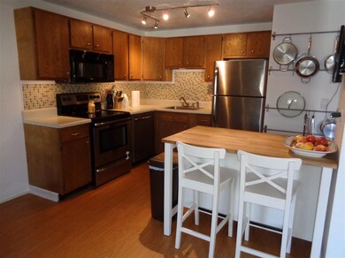 Updated kitchen with stainless steel appliances and wood flooring