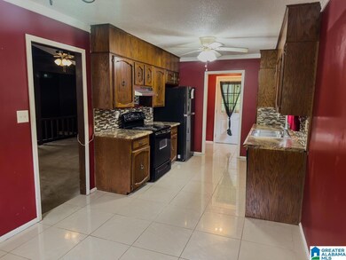 Nice kitchen with laundry room that leads to a covered deck and spacious back yard with pool.