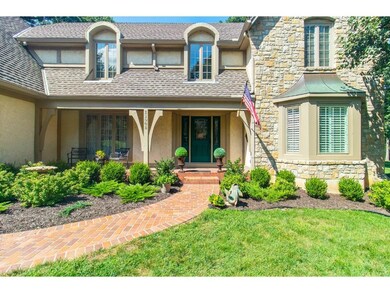 Stucco and stone facade with lovely front porch. N