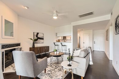 Living room featuring a ceiling fan, baseboards, 