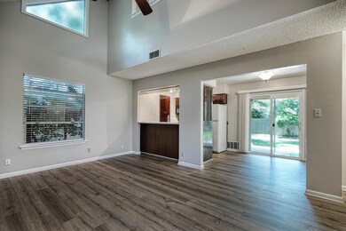 Unfurnished living room with dark wood-style floo