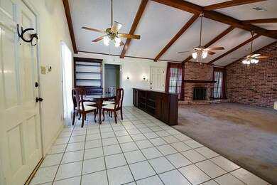 Tile floors extend from breakfast nook to the kitchen