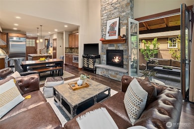 Vaulted ceilings with floor to ceiling elegant stone fireplace. Inviting french doors to your outside year round patio.