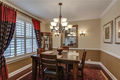 Formal dining room with hardwood floor, crown moulding, chair rail, sconce lighting, custom 4