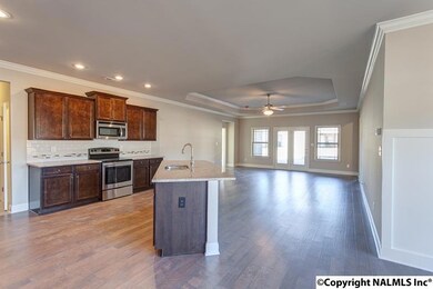 The dining room, kitchen, and living room all flow together while maintaining their own spaces.