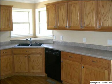 Corner sink in the Kitchen. There is room enough f