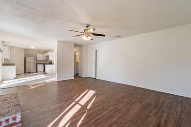 Unfurnished living room with ceiling fan, sink, a 