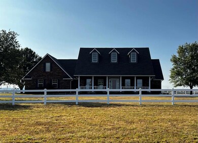 New england style home featuring a front lawn and 