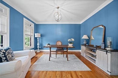 Office area featuring ornamental molding, hardwood