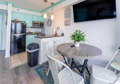 Kitchen featuring freestanding refrigerator, stain