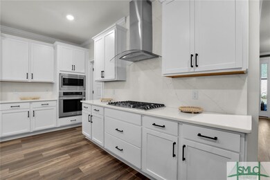 Lots of cabinetry and custom walk in pantry