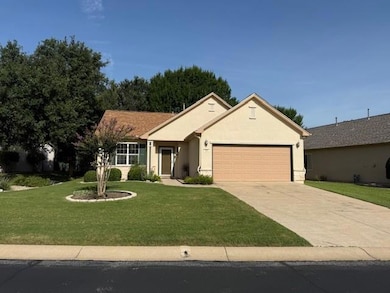 Ranch-style house featuring an attached garage, c