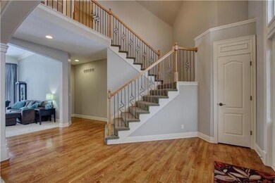 Grand staircase with wrought iron spindles.