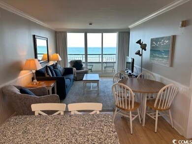 Living room featuring ornamental molding, hardwood / wood-style flooring, and plenty of natural light