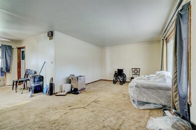 Sitting room with baseboards and carpet