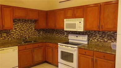 Kitchen with new granite counters and new tile bac