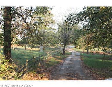 Exterior Front. Tranquil winding asphalt driveway from high way to house complete with a split rail fence.