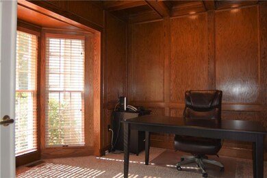Spacious office with custom woodwork, gorgeous bay