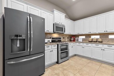 Kitchen with stainless steel appliances, vaulted 