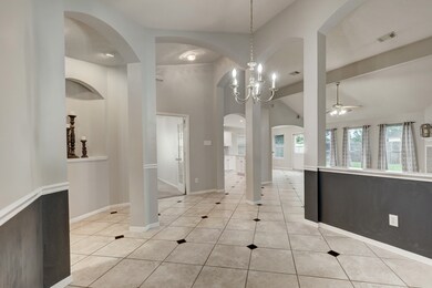 You have so many nice decorative niches. The columns define the space, but still make the floor plan feel so open. You can see into the bonus/game room, the kitchen and the breakfast room at the far corner.