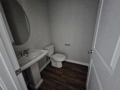 Bathroom featuring toilet and wood finished floors