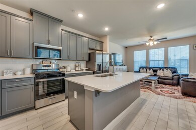 Kitchen with a sink, gray cabinetry, light counter