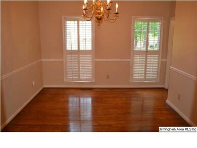 Formal dining room with hardwood floors, chair rai